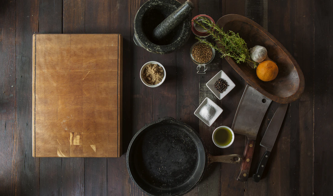 Overhead view of a chopping board, mortar, and cooking ingredients